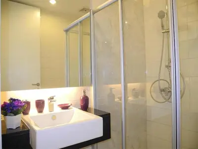 a bathroom with a sink and a shower at 2 Bedrooms Beachfront Apartment in Patong in Patong Beach