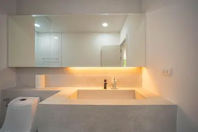 a bathroom with a sink and a mirror and a toilet at Kamala Natural Modern ApartmentHigh Speed WiFiBig Living Room in Kamala Beach