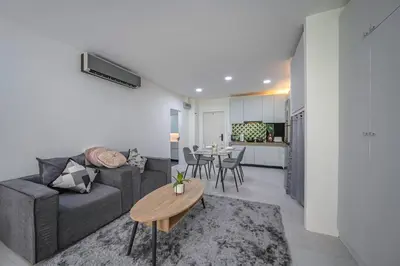 a living room with a couch and a table at Kamala Natural Modern ApartmentHigh Speed WiFiBig Living Room in Kamala Beach