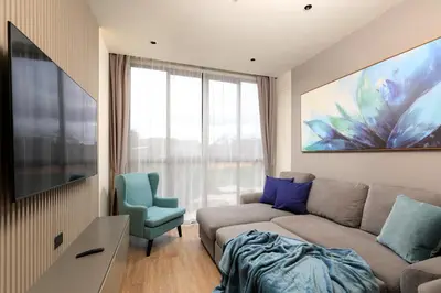 a living room with a couch and a window at New 1bdr Apartment Layan C518 in Ko Kala