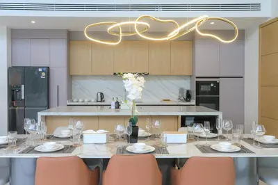 a dining room with a table with chairs and a chandelier at Asherah Villa By Asherah Team in Ban Phru Champa