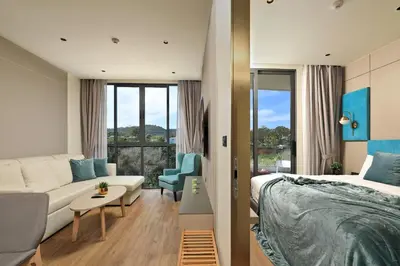 a hotel room with a bed and a couch at New 1 bdr Apartment near Layan beach C610 in Ko Kala