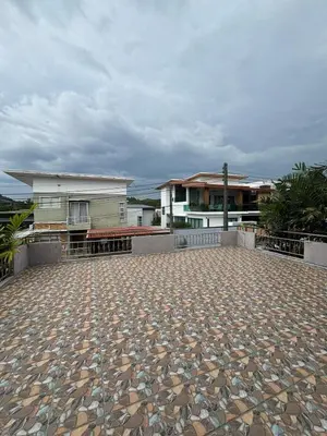 a large patio with a house in the background at Spacious and cozy Thai House in Ban Bang Khu