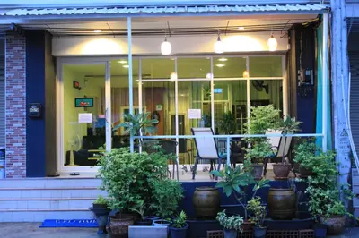 a store front with potted plants in front of it at Ananas Central Phuket Hostel in Ban Ket Ho