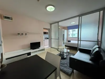a living room with a couch and a tv and a table at Dcondo kathu phuket in Kathu