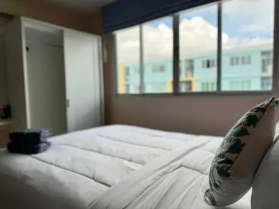 a white bed in a bedroom with a large window at Dcondo kathu phuket in Kathu