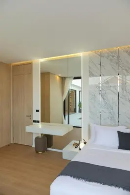 a bedroom with a bed and a desk with a mirror at Le Da Villas 5BR Private Pool Villa, Bangtao Beach Phuket in Laguna Phuket