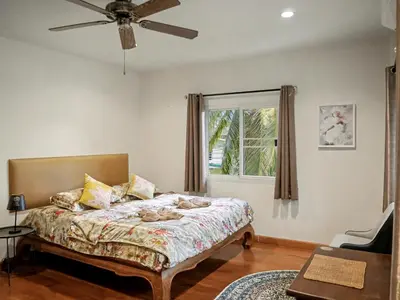a bedroom with a bed and a window at 3 Bedrooms - 2 floor with garden in Prime Location in Thalang