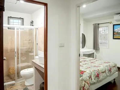 a bathroom with a bed and a toilet and a sink at 3 Bedrooms - 2 floor with garden in Prime Location in Thalang