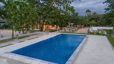 a swimming pool in the backyard of a house at Private beachfront Villa Natai with 5 bedrooms in Ban Na Tai