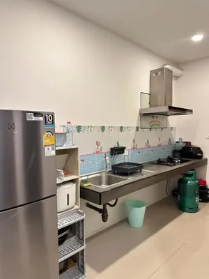 a kitchen with a stainless steel refrigerator and a sink at The Passion House in Ban Na Nai