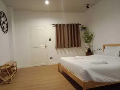 a bedroom with a white bed and a window at RQ Phuket Patong Beach by Collection O in Patong Beach