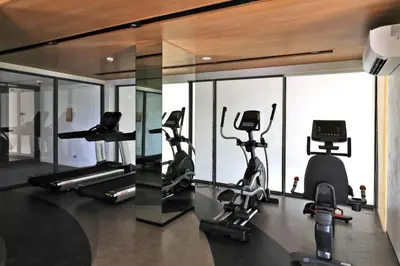 a gym with several treadmills and elliptical machines at New 1 bdr Apartment in Laguna 50m from the Beach in Bang Tao Beach