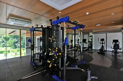 a gym with treadmills and elliptical machines at New 1 bdr Apartment in Laguna 50m from the Beach in Bang Tao Beach