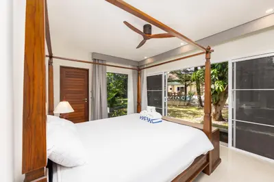 a bedroom with a bed and a large window at Villa Emilia Private Pool Naiharn in Rawai Beach