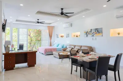 a living room with a couch and a table at Phuket Arkadia Home in Nai Harn Beach