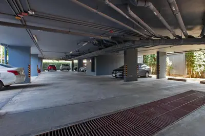 a large parking garage with cars parked in it at 6th avenue surin in Surin Beach
