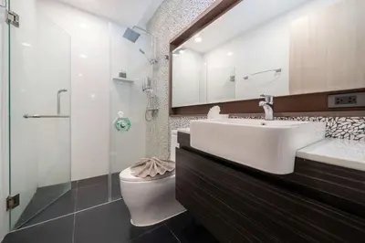 a bathroom with a sink and a toilet and a mirror at Tropical Stay at Apartment B603 in VV Patong in Patong Beach