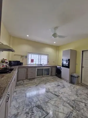 a large kitchen with marble floors and a white refrigerator at Superb 3 Bed Pool Villa in Ban Saiyuan (1)