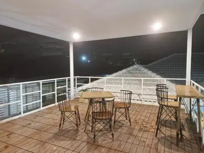 a balcony with a table and chairs and a stadium at Superb 3 Bed Pool Villa in Ban Saiyuan (1)