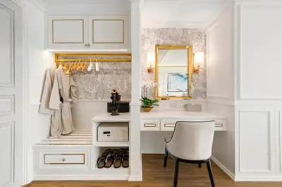 a dressing room with a white vanity and a chair at The Cyan at Patong Hotel in Patong Beach