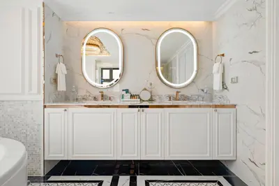 a bathroom with two sinks and two mirrors at The Cyan at Patong Hotel in Patong Beach