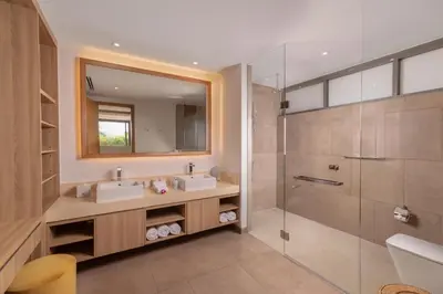 a bathroom with two sinks and a shower at Villa Narissa in Kamala Beach