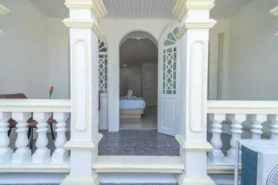 a white house with a bathroom with a tub at Seaside Patong House - Newly Open in Patong Beach