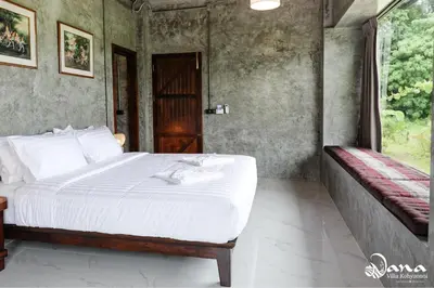 a bedroom with a bed and a window at Nana Villa in Ko Yao Noi