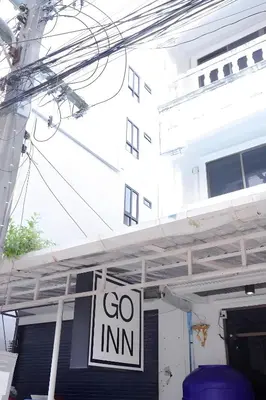 a sign that says go inn hanging in front of a building at XX Go Inn Phuket Patong Beach - ป่าตองบีช in Patong Beach