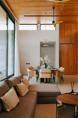 a living room with a couch and a table at Botanica Foresta Villa in Thalang
