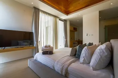 a bedroom with a large bed and a large window at Luxpride Villa by Wallaya Villas in Ban Thalat Choeng Thale