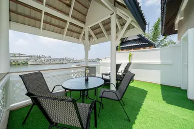 a patio with a table and chairs on a balcony at The Lake Front Laguna Alla13 in Laguna Phuket