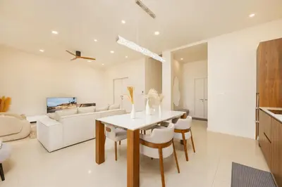 a kitchen and living room with a table and chairs at Villa Aura 3BR Private Pool Near Naiharn Beach by TropicLook in Rawai Beach