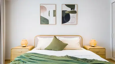 a bedroom with a bed with two night stands at BeachSide and SeaSide Residences Apartment 200 m to Bang Tao Beach in Bang Tao Beach