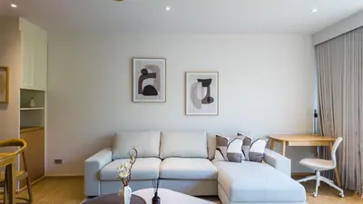 a living room with a couch and a table at BeachSide and SeaSide Residences Apartment 200 m to Bang Tao Beach in Bang Tao Beach