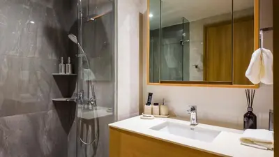 a bathroom with a sink and a shower at BeachSide and SeaSide Residences Apartment 200 m to Bang Tao Beach in Bang Tao Beach