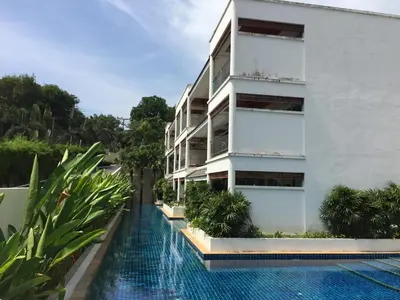 an apartment building with a swimming pool at Bel Air Panwa Big Apartment in south Phuket near Ao Yon Beach, 3rd floor in Ban Ao Makham