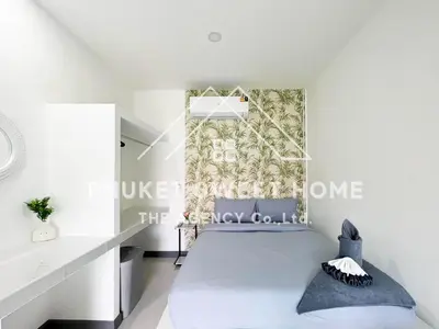 a white bedroom with a bed and a window at Naiharn Green Valley number 15 16 in Rawai Beach