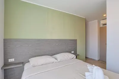 a bedroom with a bed with two pillows on it at Big Buddha View - 1 bedroom T3 - 228 in Chalong