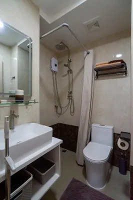 a bathroom with a sink and a shower and a toilet at Pool View Tropic Studio in Ban Mai Salae