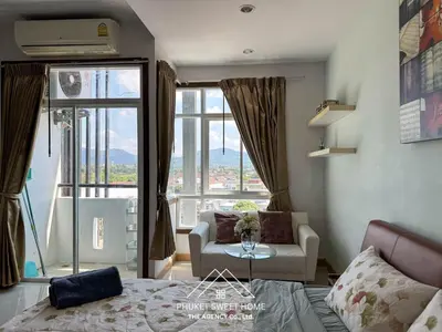 a room with a bed and a couch and a window at Condo fodr rent The bell 50 in Ban Klang