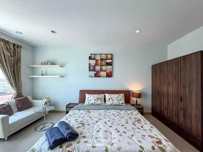 a bedroom with a large bed and a couch at Condo fodr rent The bell 50 in Ban Klang