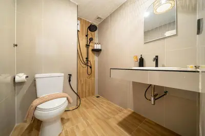 a bathroom with a toilet and a sink at Wink Central 9 Patong Beach Phuket in Patong Beach