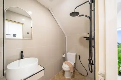a bathroom with a sink and a shower at Wink Central 9 Patong Beach Phuket in Patong Beach