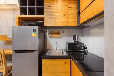 a kitchen with a stainless steel refrigerator and a sink at Relife Rio 2 min to Nai Harn beach in Rawai Beach