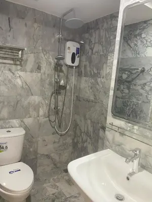 a bathroom with a shower and a toilet and a sink at май кхао Студия в кондо 777 in Koh Lone