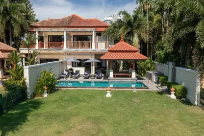 a house with a swimming pool in a yard at Golden Cotton Villa 3BR Lagoon View by GRF in Laguna Phuket