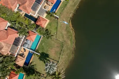 an overhead view of a house and a body of water at Golden Cotton Villa 3BR Lagoon View by GRF in Laguna Phuket