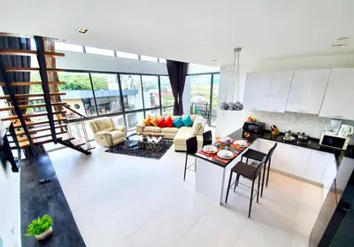 a living room with a couch and a table at Beautiful Modern Penthouse Kamala Beach in Kamala Beach
